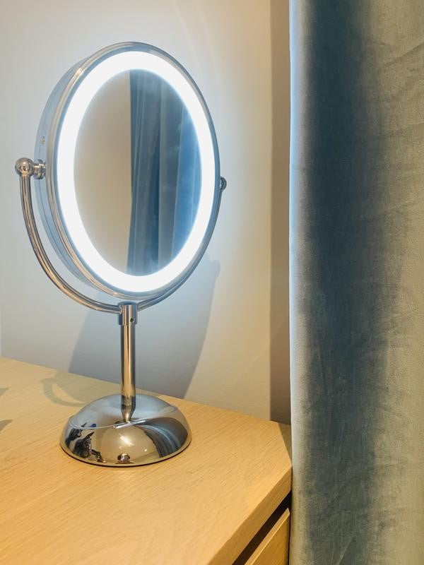 Double-sided LED mirror with 7x and 1x magnification, 360-degree rotation, and lifetime energy-efficient bulbs.