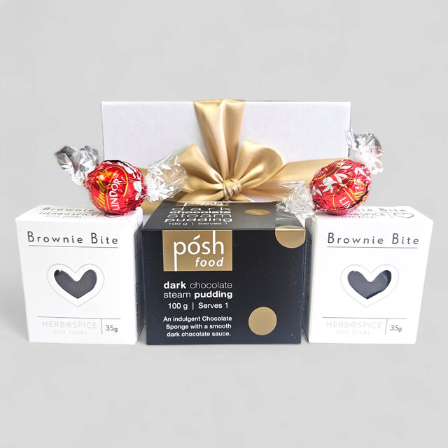 Choccy Dessert Gift Box featuring dark chocolate pudding, brownie bites, and Lindor truffles in an elegant ribboned package.