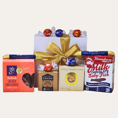 Elegant gift box filled with assorted chocolates, including cookies, fudge, bars, fish, hot cocoa, and Lindor chocolates.