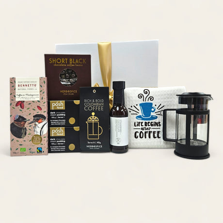 Elegant coffee and dessert gift box featuring premium coffee, gourmet chocolate, and a charming tea towel for coffee lovers.
