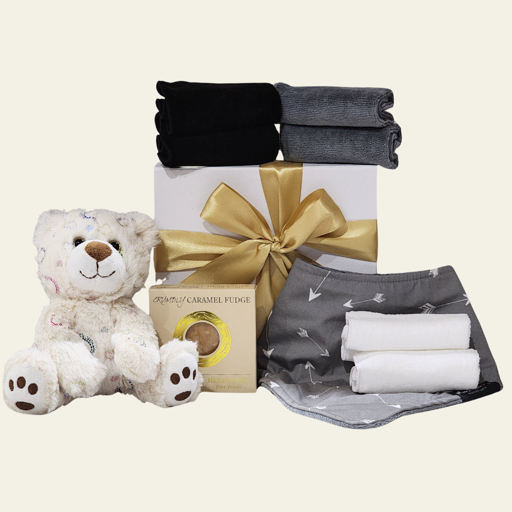 Elegant 'Congratulations Baby' gift box filled with stylish bib, soft cloths, cuddly bear, and fudge for new parents.