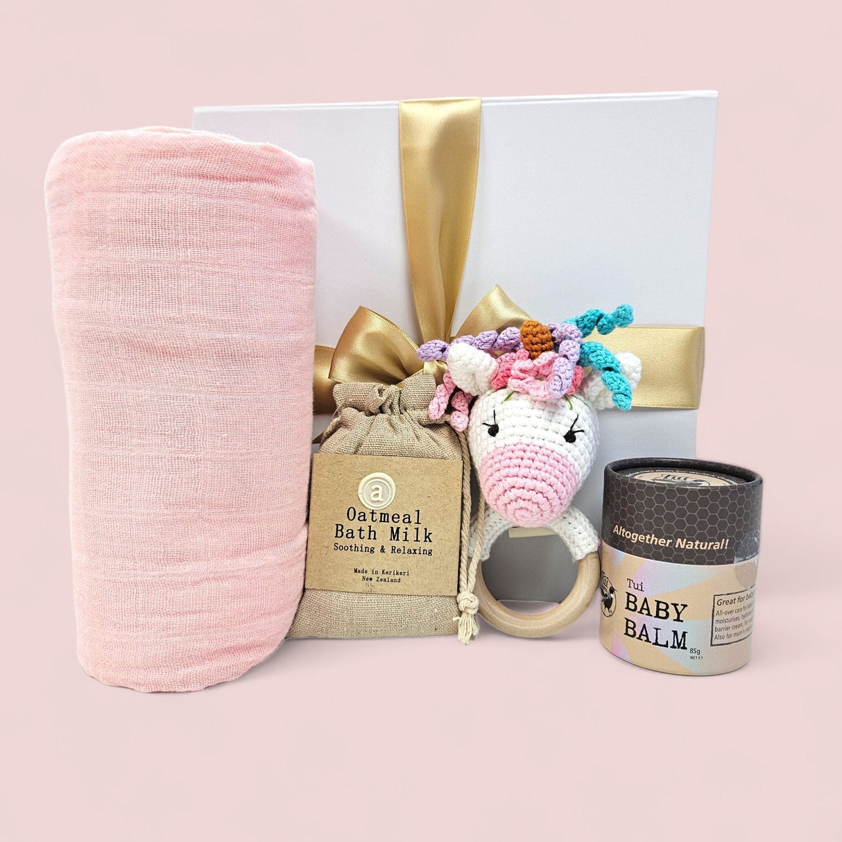 Cuddly Baby Unicorn Gift Box with essential baby items for comfort, including bath milk, swaddle, rattle, and soothing balm.