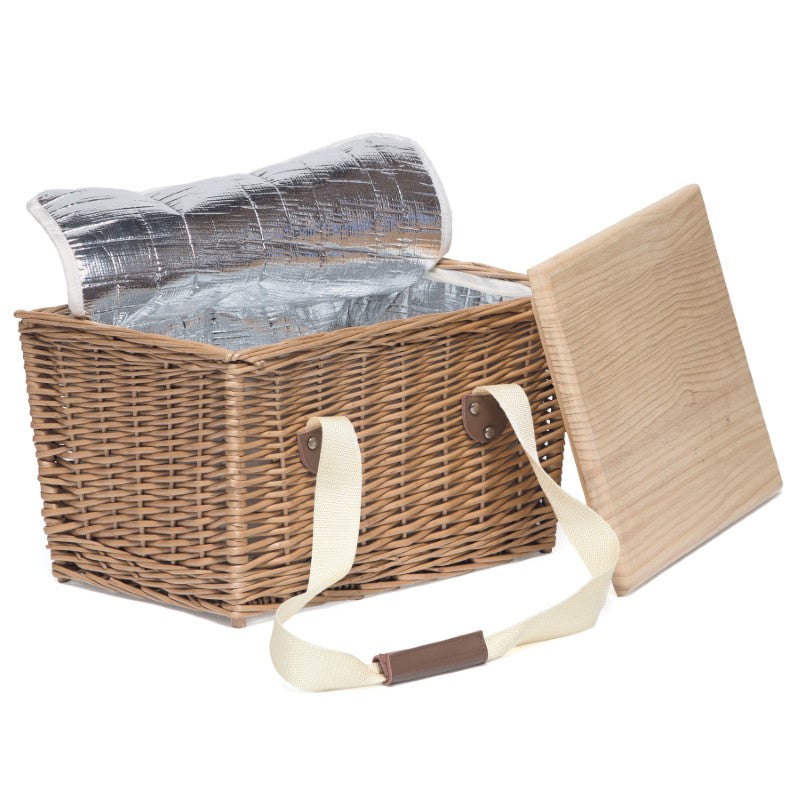 Wicker picnic basket with cooler, removable serving board lid, insulated compartment, and stylish leather handles.
