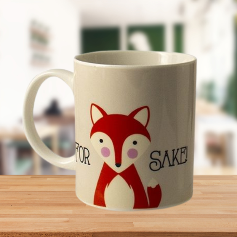 Cheerful ceramic mug with "For Fox Sake" phrase, perfect for coffee or tea lovers looking for a daily laugh.