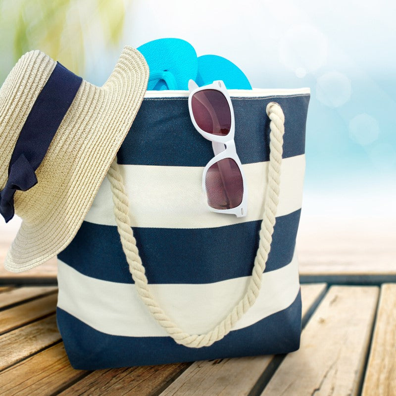 Oversized beach tote bag with rope handles, made of durable cotton canvas, featuring secure zip closure for essentials.
