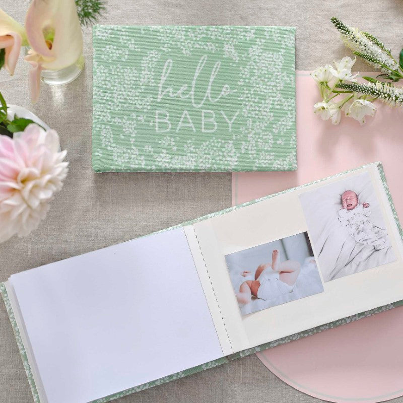Elegant linen baby photo album with 'Hello Baby' cover, featuring photo spaces and memory pages for cherished keepsakes.