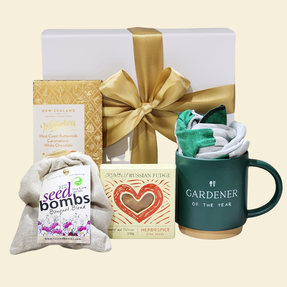 Elegant gift set for gardeners featuring a mug, seed bombs, gloves, and gourmet treats in a beautiful magnetic closure box.