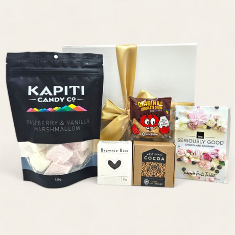 Gourmet gift box featuring premium hot chocolate treats, including marshmallows, chocolate, and cookies, elegantly presented.