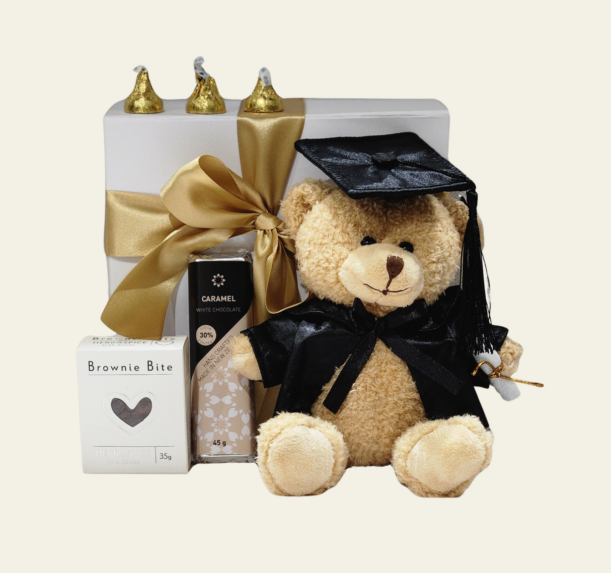 Graduation gift box with mini brownie, teddy bear, Hershey's Kisses, caramel chocolate bar, and elegant ribboned packaging.