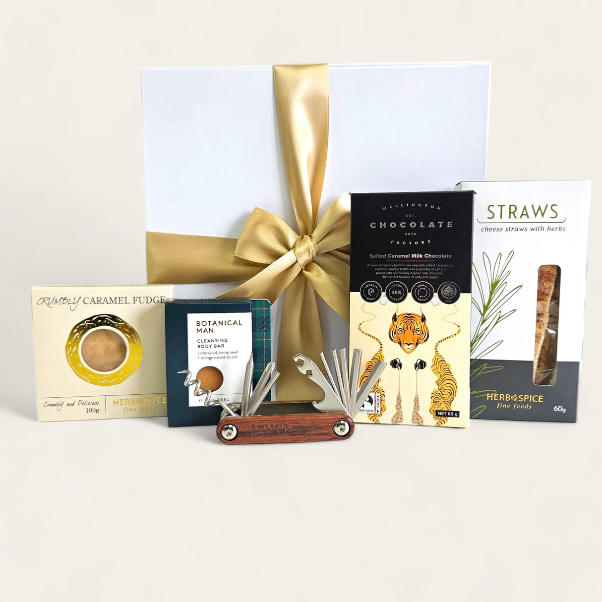 Elegant gift box filled with gourmet treats, snacks, and practical tools, perfect for gifting to men on any occasion.