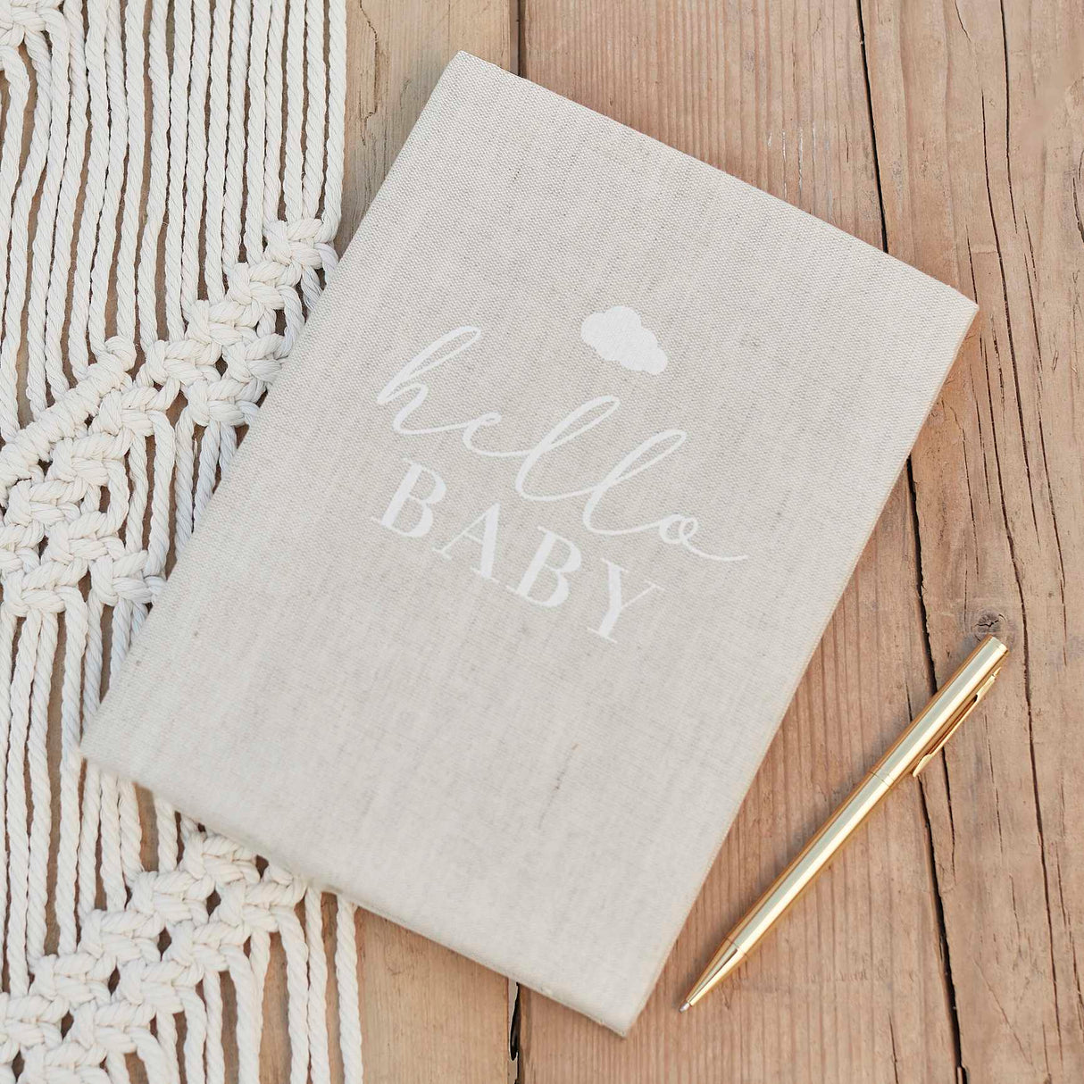 Charming linen baby journal for recording milestones and heartfelt guest messages, perfect for baby showers and keepsakes.