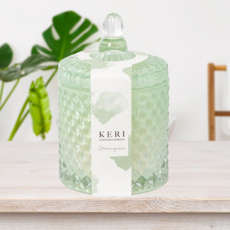 Keri Scented Lemongrass Candle in a white cut glass jar, offering fresh floral notes and up to 25 hours of burn time.