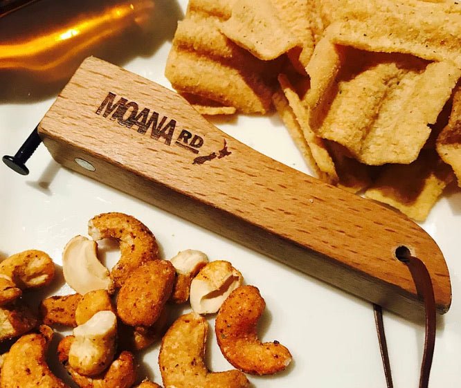 Moana Road wooden bottle opener shaped like a nail, featuring magnets for cap-catching and easy fridge storage.