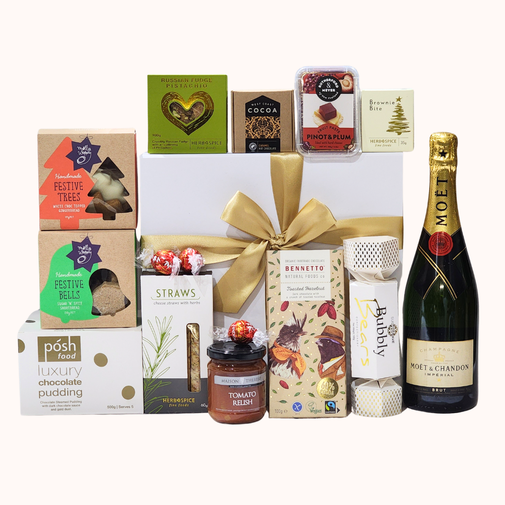 A festive gift box filled with gourmet treats, champagne, chocolates, and holiday-themed snacks for a luxurious celebration.