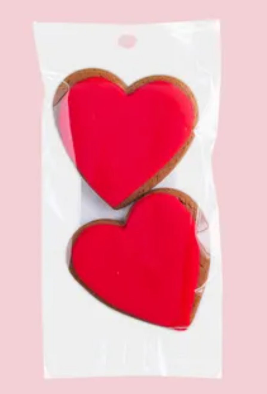 Heart-shaped ginger cookies with red icing in a twin pack, perfect for gifting and celebrating special moments.