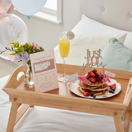Deluxe Breakfast in Bed Kit featuring customizable menu, elegant toppers, and festive balloons for a memorable morning.