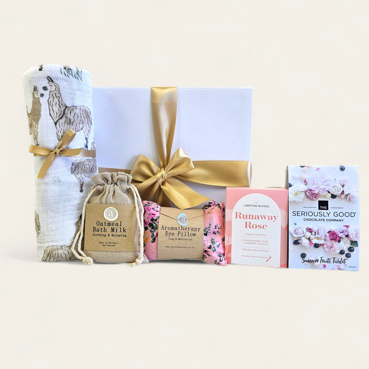 Mum And Bub Gift Box featuring cozy baby swaddle, soothing bath milk, relaxing tea, gourmet chocolate, and an eye pillow.