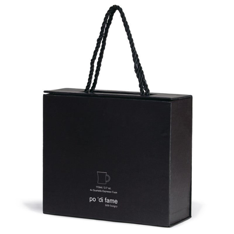 Sleek modern Quartet Espresso Set with four matte black ceramic cups, elegantly packaged for coffee enthusiasts.