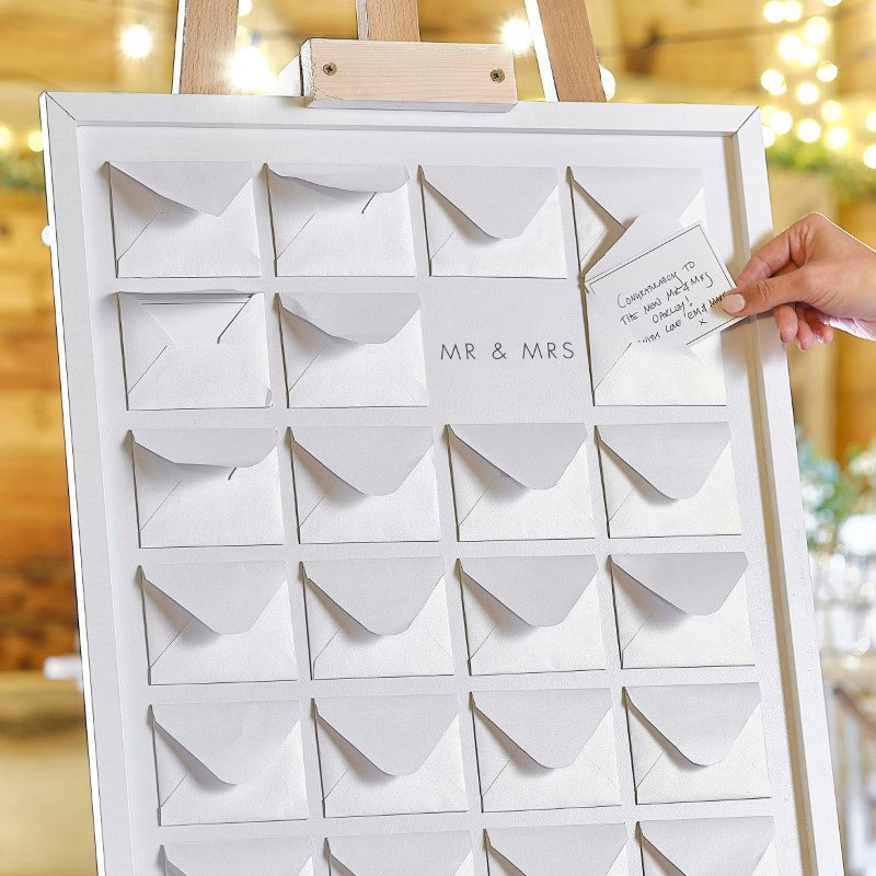 Wooden frame with 27 mini pearlised envelopes for heartfelt wedding guest messages, ideal for rustic barn-themed receptions.