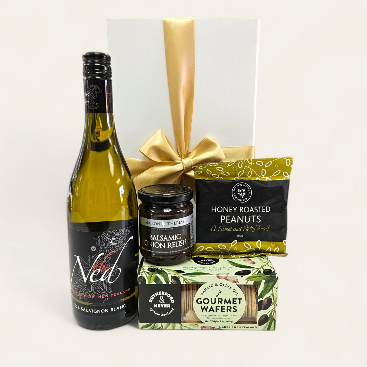 Elegant Sav And Nibbles Gift Box featuring Sauvignon Blanc, gourmet snacks, and beautiful packaging tied with a ribbon.
