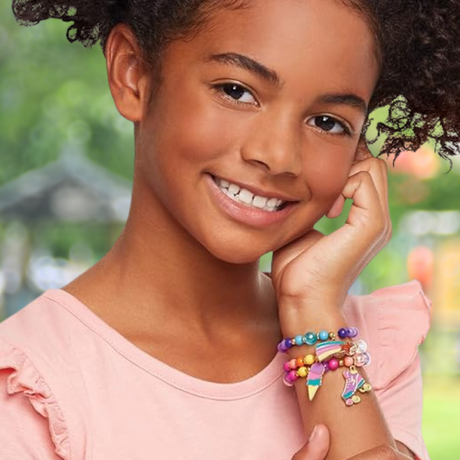 Colorful Charm Bracelet Making Kit with beads, charms, and elastic cord for creative jewelry design and crafting fun.