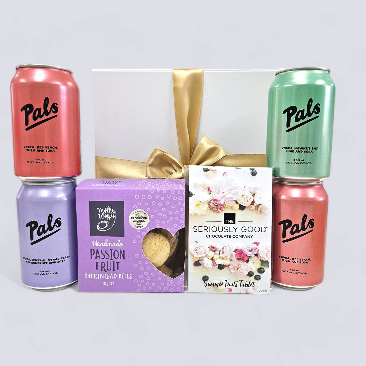 Brightly packaged Summer Refresher Gift Box featuring vodka cans, passionfruit shortbread, and chocolate tablet for year-round joy.