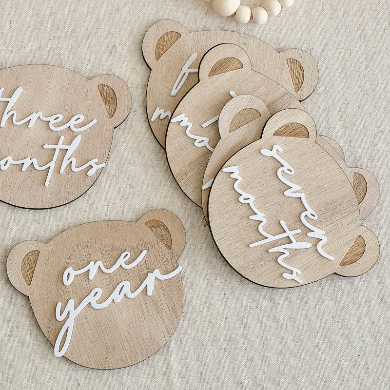 Bear-shaped milestone signs for baby's first year, including "HELLO WORLD" and "ONE YEAR" to celebrate growth milestones.