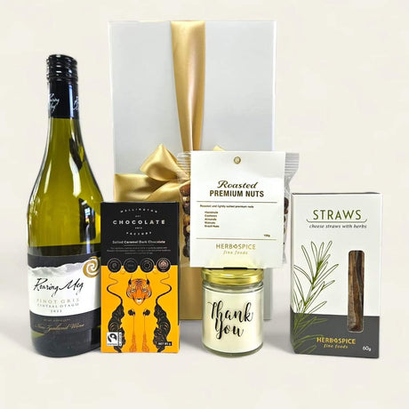 Gift box with wine, chocolate, nut mix, and a scented candle, elegantly packaged with a ribbon. Perfect for expressing gratitude.