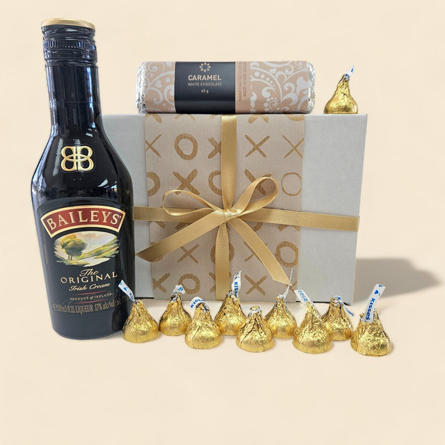 Gift box featuring Baileys Irish Cream, a white chocolate bar, and Hershey's Kisses, perfect for heartfelt gifting.