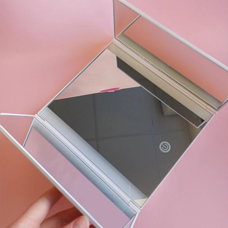 Lighted tri-panel LED mirror with touch control and adjustable brightness for flawless makeup application.