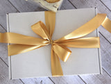 Deluxe Chocolate Treat Box featuring premium chocolates and sweets in an elegant gift box with a gold bow.