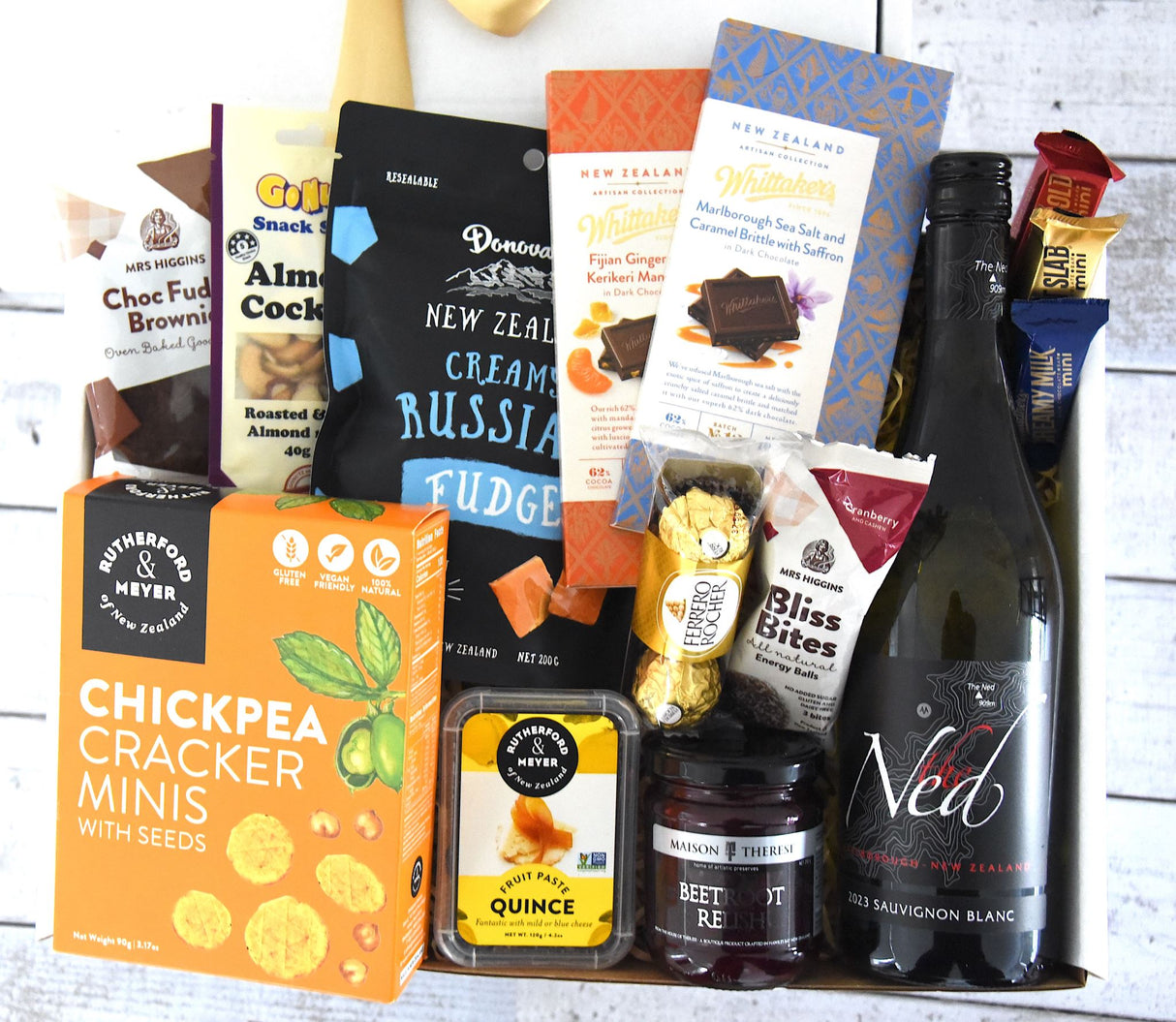 Luxurious Vino & Gourmet Delight Box featuring fine wine, gourmet snacks, chocolates, and delightful treats elegantly presented.