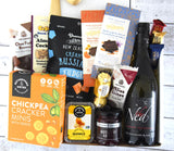 Luxurious Vino & Gourmet Delight Box featuring fine wine, gourmet snacks, chocolates, and delightful treats elegantly presented.