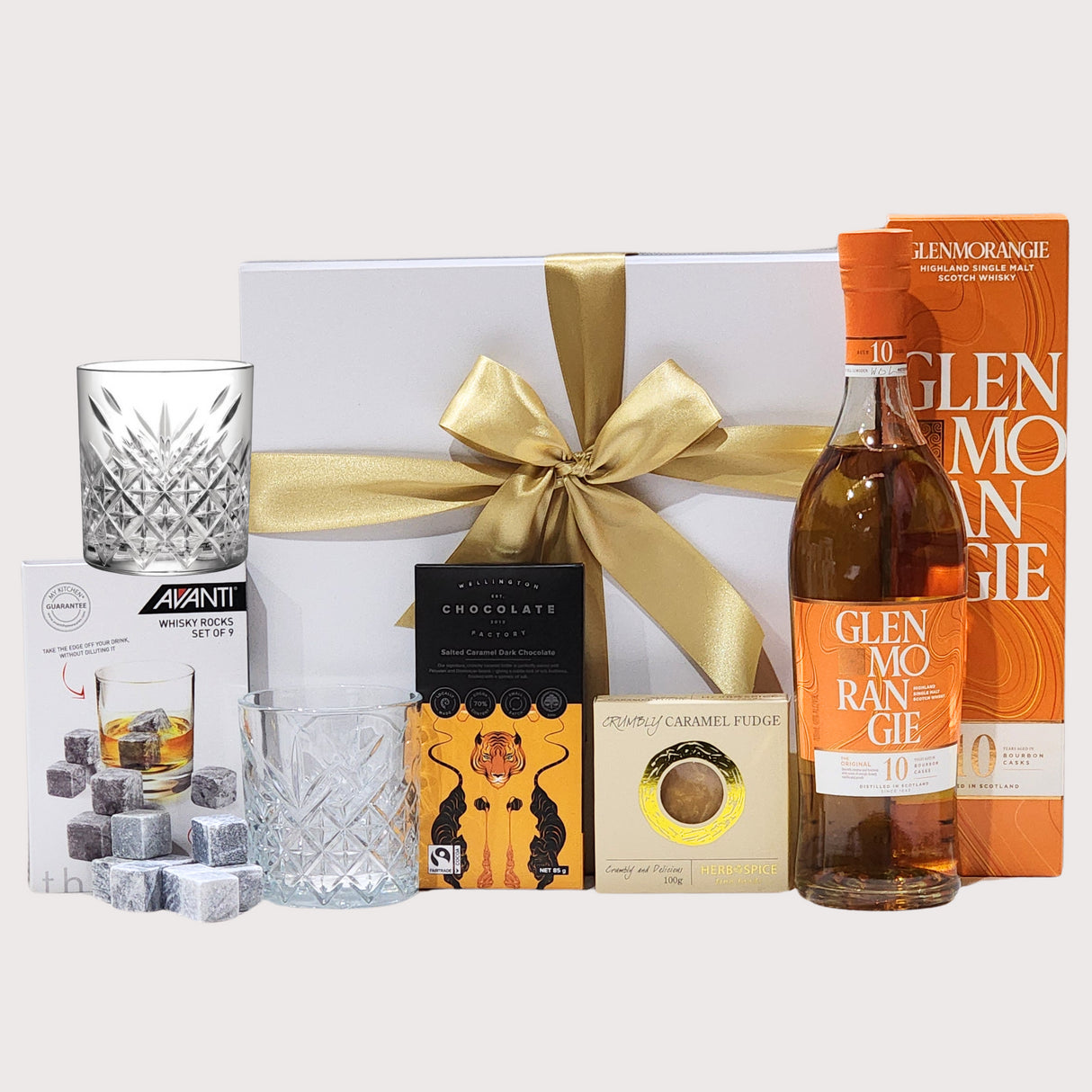 Elegant gift box featuring Glenmorangie whiskey, traditional glasses, chocolate, fudge, and whiskey rocks set.