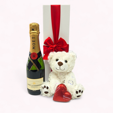 Luxurious gift box featuring Moët Champagne, chocolate heart, teddy bear, and elegant presentation for special occasions.