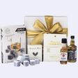 Elegant Whisky Rocks gift box featuring premium whiskeys, gourmet snacks, and reusable chilling stones for an indulgent experience.