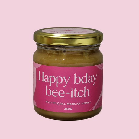 NZ Manuka Honey 250g in a "Happy Birthday Bee-itch" jar, perfect for gifts and sweetening treats.