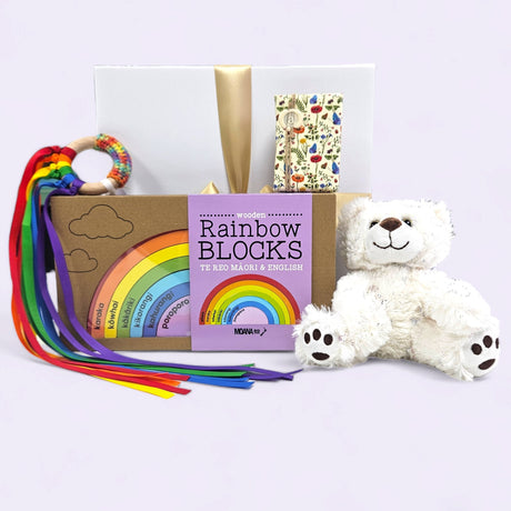 Bright Baby Gift Box featuring a teddy bear, rainbow blocks, teether, and soap, beautifully presented for newborns.