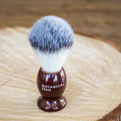 Elegant rosewood handle shaving brush with ultra-soft faux badger bristles for a luxurious, smooth shaving experience.