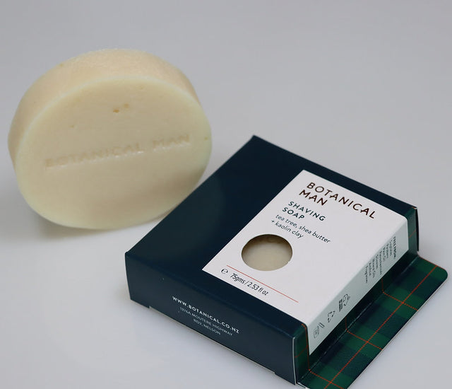 Botanical Man Shaving Soap infused with Tea Tree Oil, Shea Butter, and Kaolin Clay for a rich, moisturizing lather.