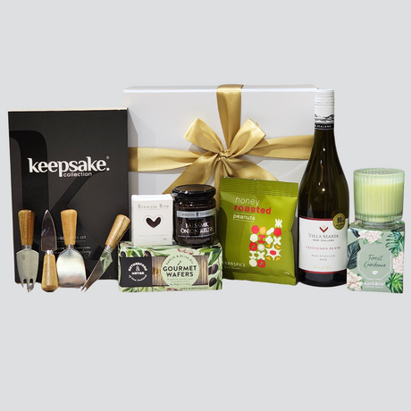 Elegant Home gift box featuring a scented candle, gourmet snacks, cheese knife set, and Sauvignon Blanc in a premium white box.