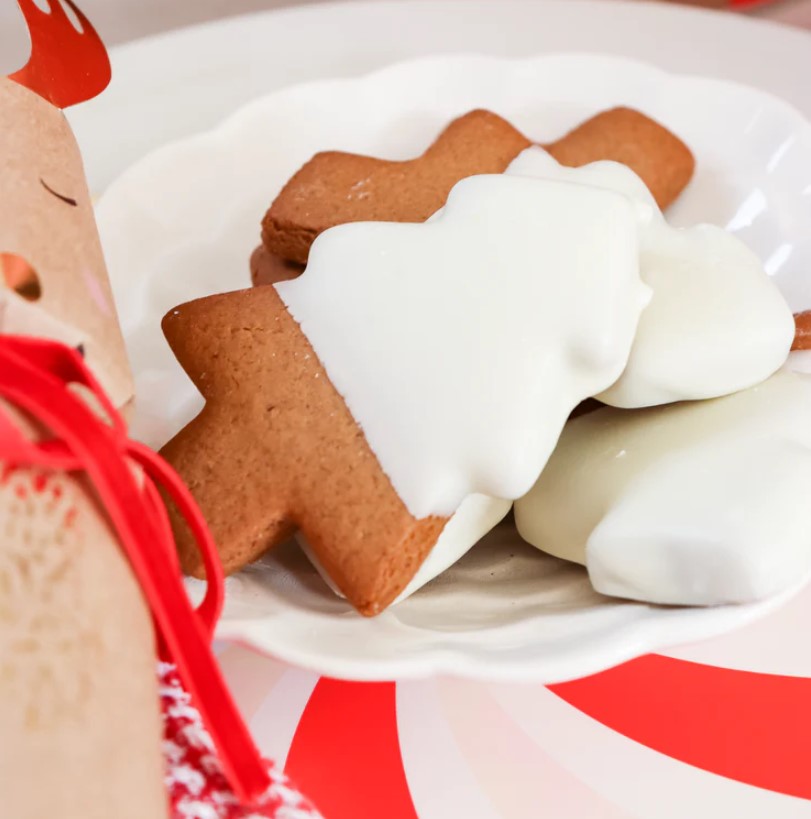 Molly Woppy Gingerbread Festive Tree Cookies shaped like Christmas trees, dipped in white chocolate for a holiday treat.