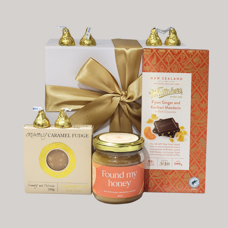 A luxurious gift box with Manuka honey, gourmet chocolates, and caramel fudge, perfect for celebrating love and special moments.