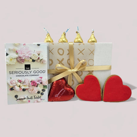 Hearts And Kisses Gift Box featuring assorted chocolates and ginger cookies, beautifully packaged for a thoughtful gift.