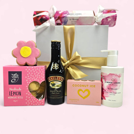 Elegant pink gift box with luxurious treats, perfect for Mother's Day or birthdays, including Baileys and handmade sweets.