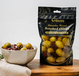 Kiwi Artisan Manuka Wood Smoked Olives in a jar, showcasing a rich, smoky flavor for a gourmet snacking experience.