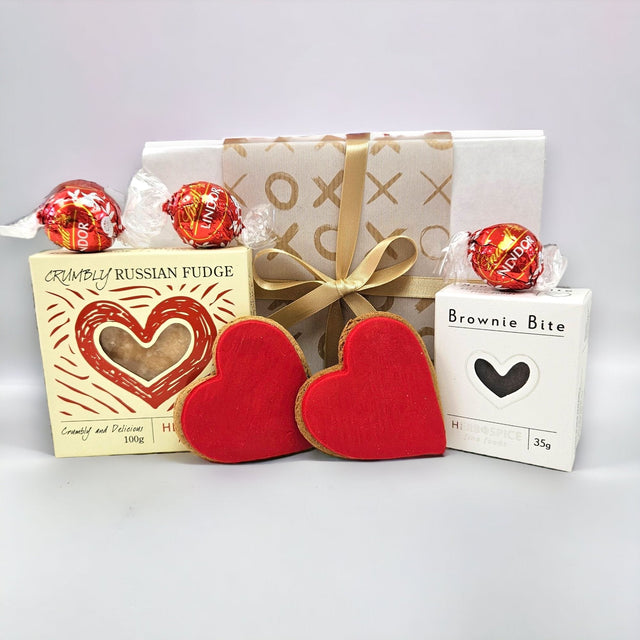 "Charming Love Gift Box featuring brownies, chocolates, and ginger biscuits, perfect for special occasions and expressing affection."