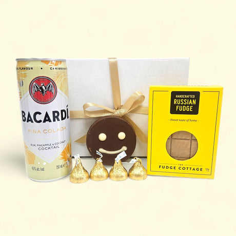 "Pina Colada Smiles Gift Box featuring a Bacardi cocktail, fudge, chocolates, and a charming ribboned gift box."