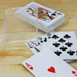 Playing cards in a sleek clear case, perfect for game nights and travel, offering style and convenience.