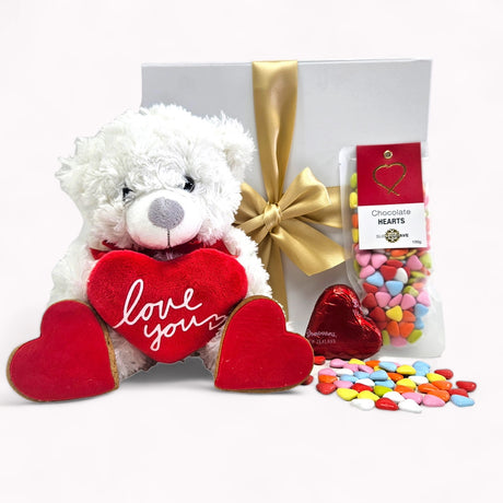 "I Love You Gift Box featuring a plush bear, chocolate hearts, and ginger cookies for romantic occasions."